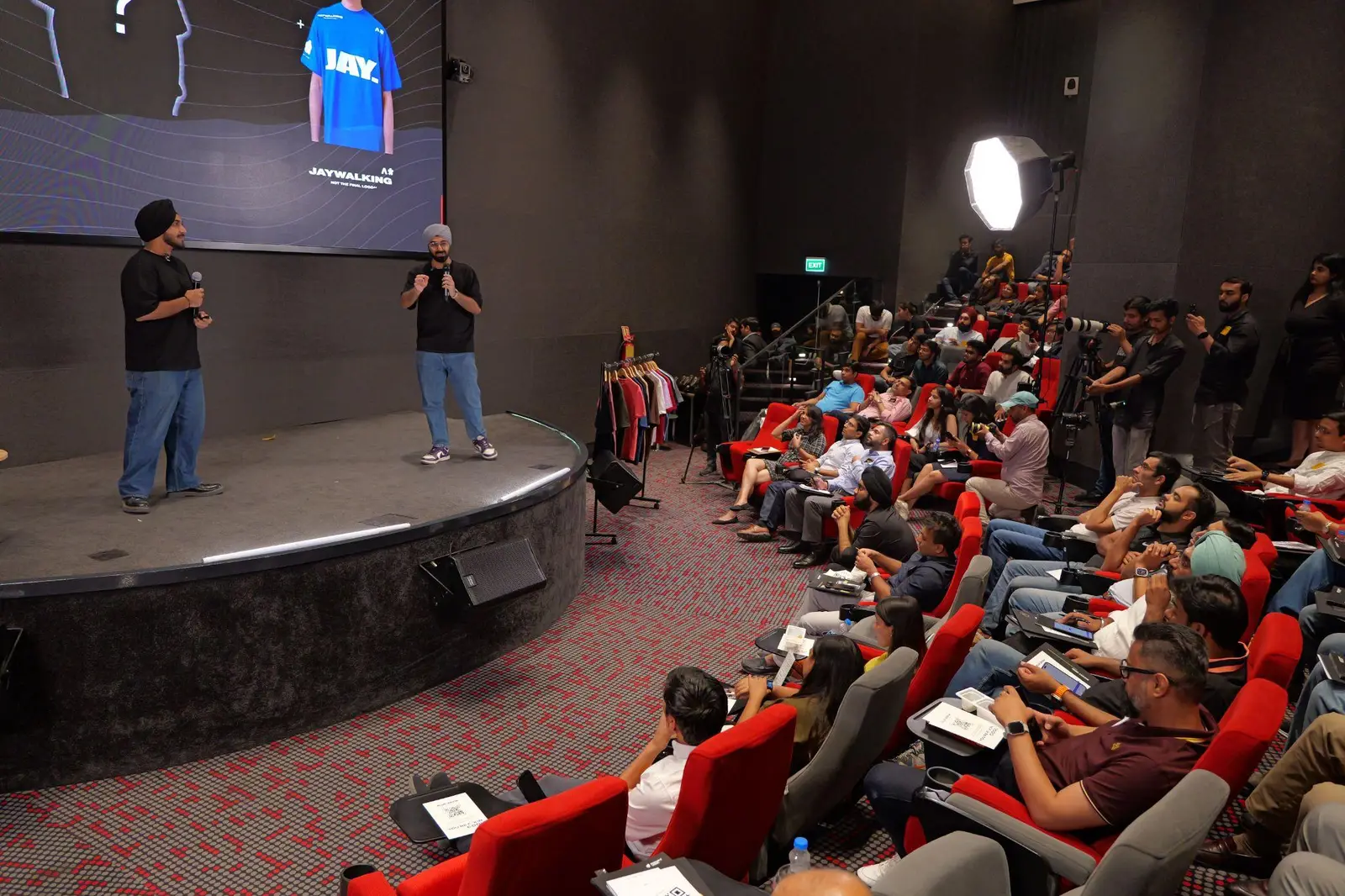 Founders pitching to a full auditorium at Demo Day