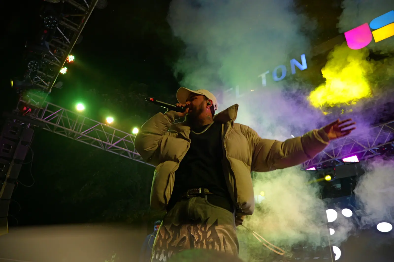 A performer on stage in coloured smoke