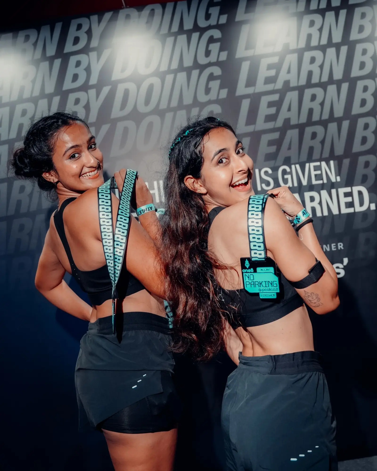 Two athletes with finisher medals at HYROX